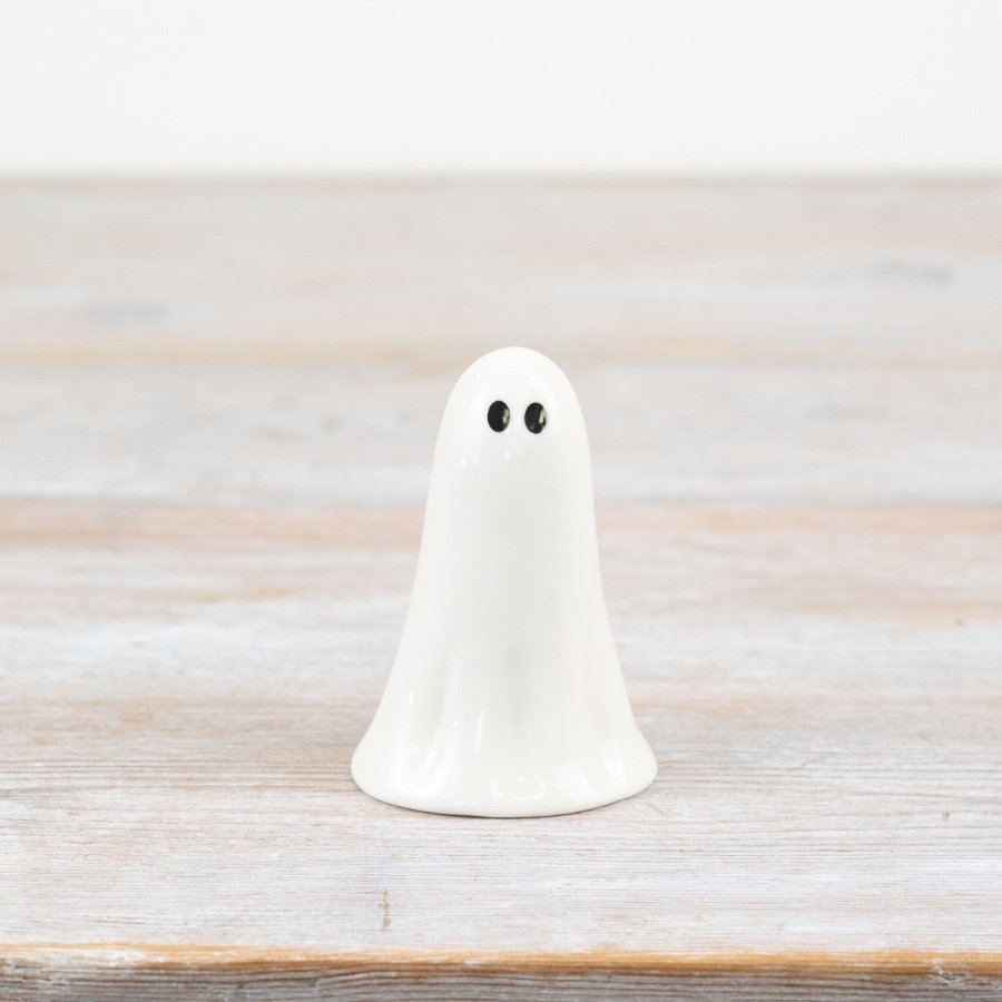 Tiny white ghost ornament with delicate details, perfect for subtle spooky decor.
