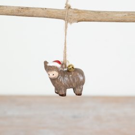 Add a rustic touch to your holiday decor with our Jute Highland Cow Hanger.