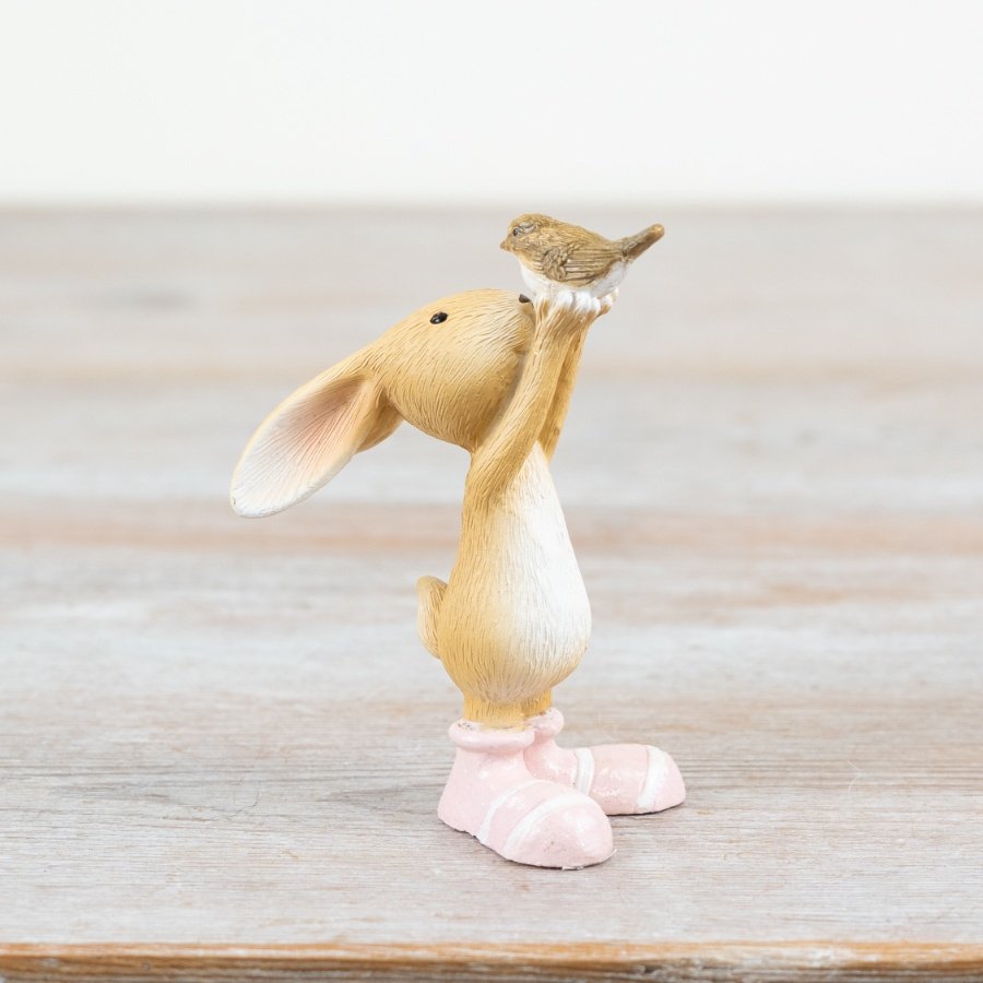 Add a touch of charm to your space with this playful decoration showcasing a rabbit and bird duo.