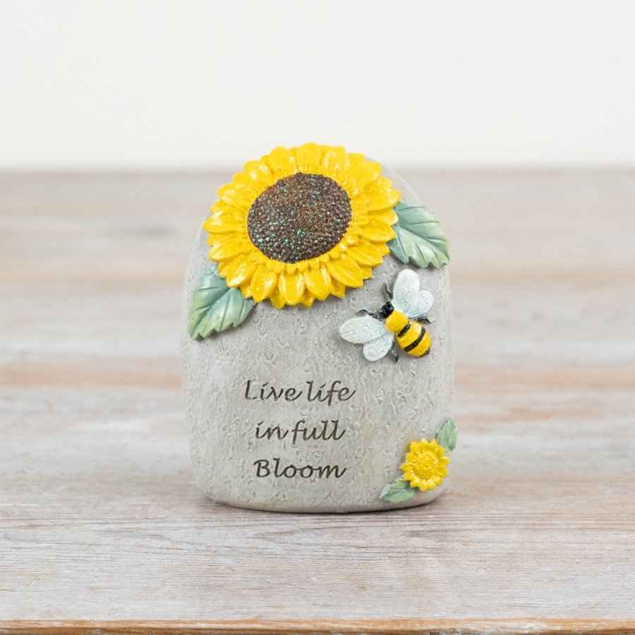 Decorative garden stone featuring a bee design.