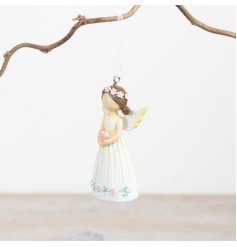 An elegant angel ornament with hanger. Pretty with pink floral details and a pink heart. 