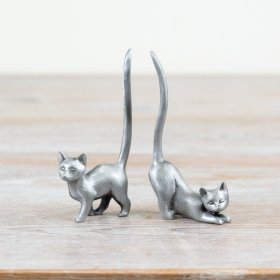 An assortment of 2 pewter ring holders in elegant cat designs.