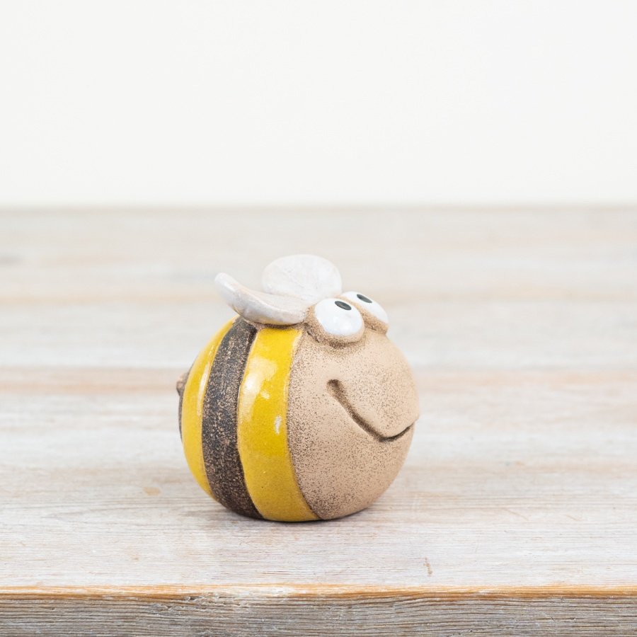 Add a touch of whimsy with our charming bee ornament featuring a playful smiley face design. 