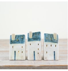 Discover the seaside allure of our Village Cottage, featuring charming LED lights and rustic accents.