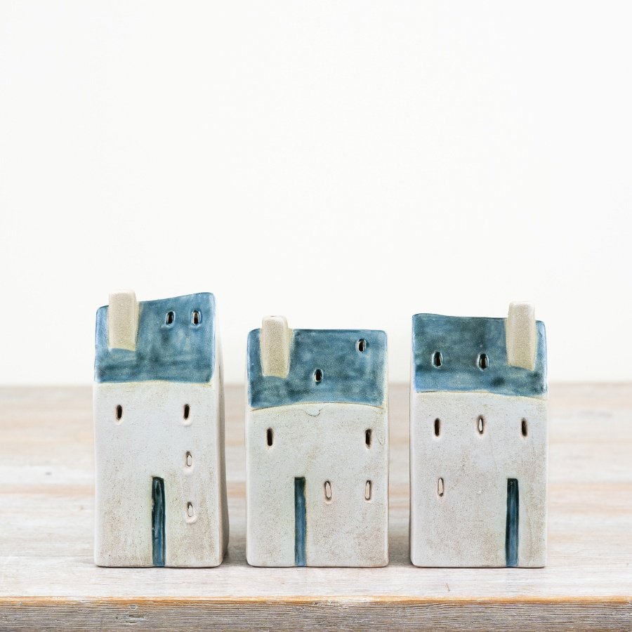 Enhance your living space with the quaint Village Cottage Windlight and its rustic design.