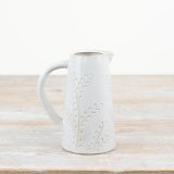 A stylish tall jug with a decorative leaf design. Complete with a natural glossy glaze.
