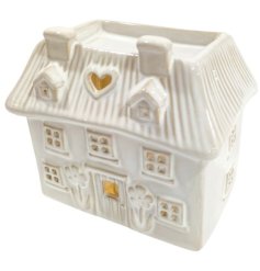 A charming house shaped oil burner with floral details, pretty cottage style windows and a heart cut out design. 