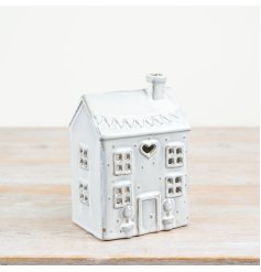 Bring warmth and style to any space with our glazed house-shaped t light holder. Perfect for creating a cosy atmosphere