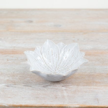 A unique flower shaped trinket dish with a natural glaze and beautiful flora details. 