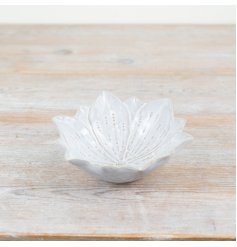 A unique flower shaped trinket dish with a natural glaze and beautiful flora details. 