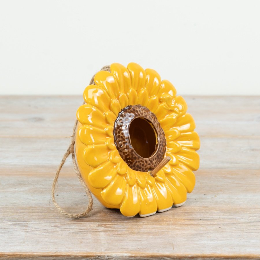 A vibrant and beautifully crafted sunflower shaped birdhouse. Complete with a rustic jute string hanger. 