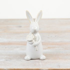 A charming rabbit ornament with glazed and unglazed features. Complete with a lovely seasonal flower. 