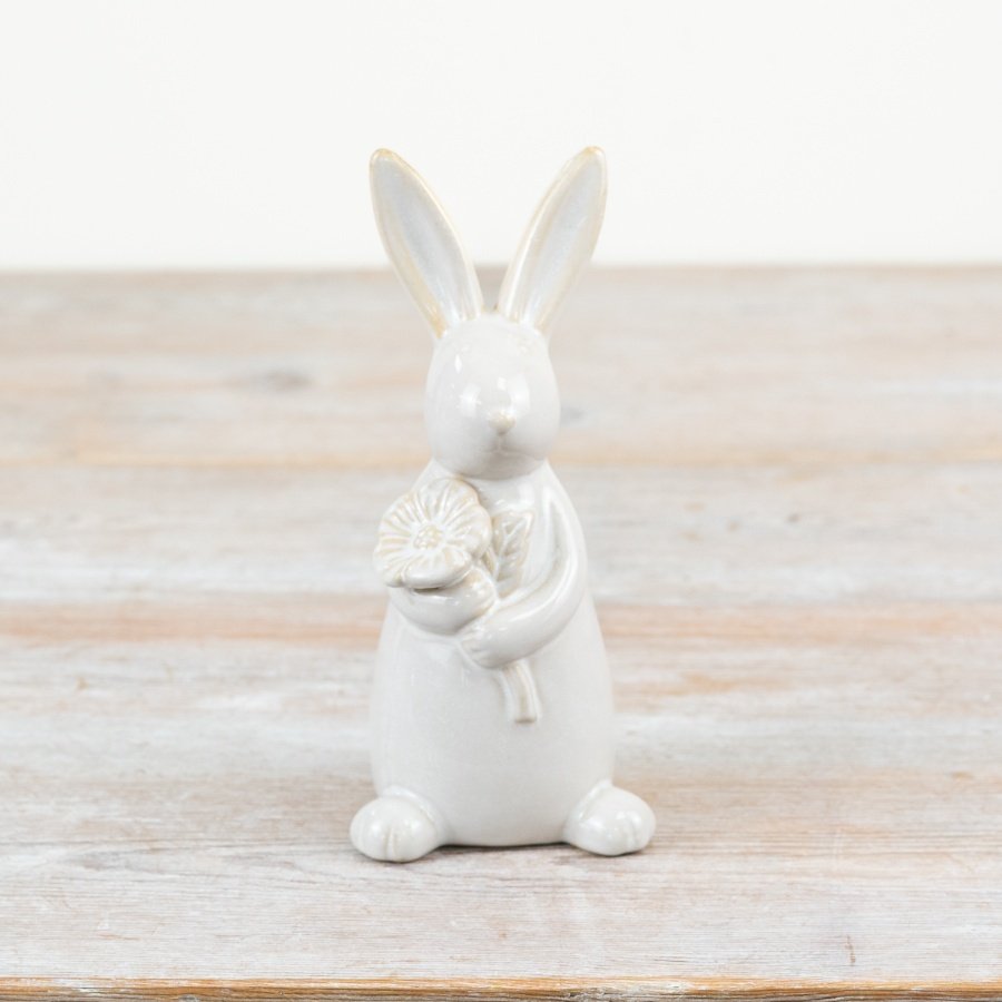 A charming rabbit ornament with glazed and unglazed features. Complete with a lovely seasonal flower. 