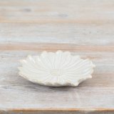 A beautifully crafted flower shaped plate with embossed detailing and a natural glaze.