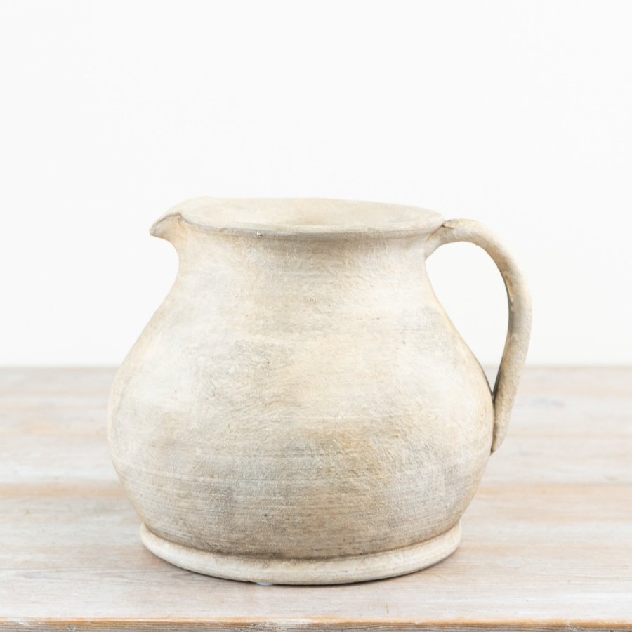Charming terracotta vase with a warm, natural earthy hue.