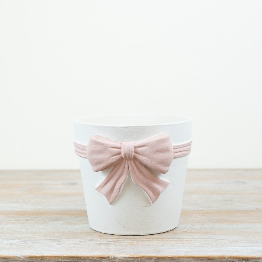 Stylish bow-shaped planter featuring beautiful pink and white hues.