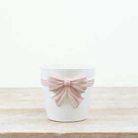 White planter featuring a large pastel pink bow for a charming, minimalist look.