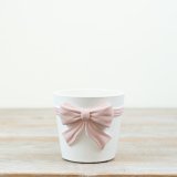 This on trend pink and white bow planter creates its own statement piece.