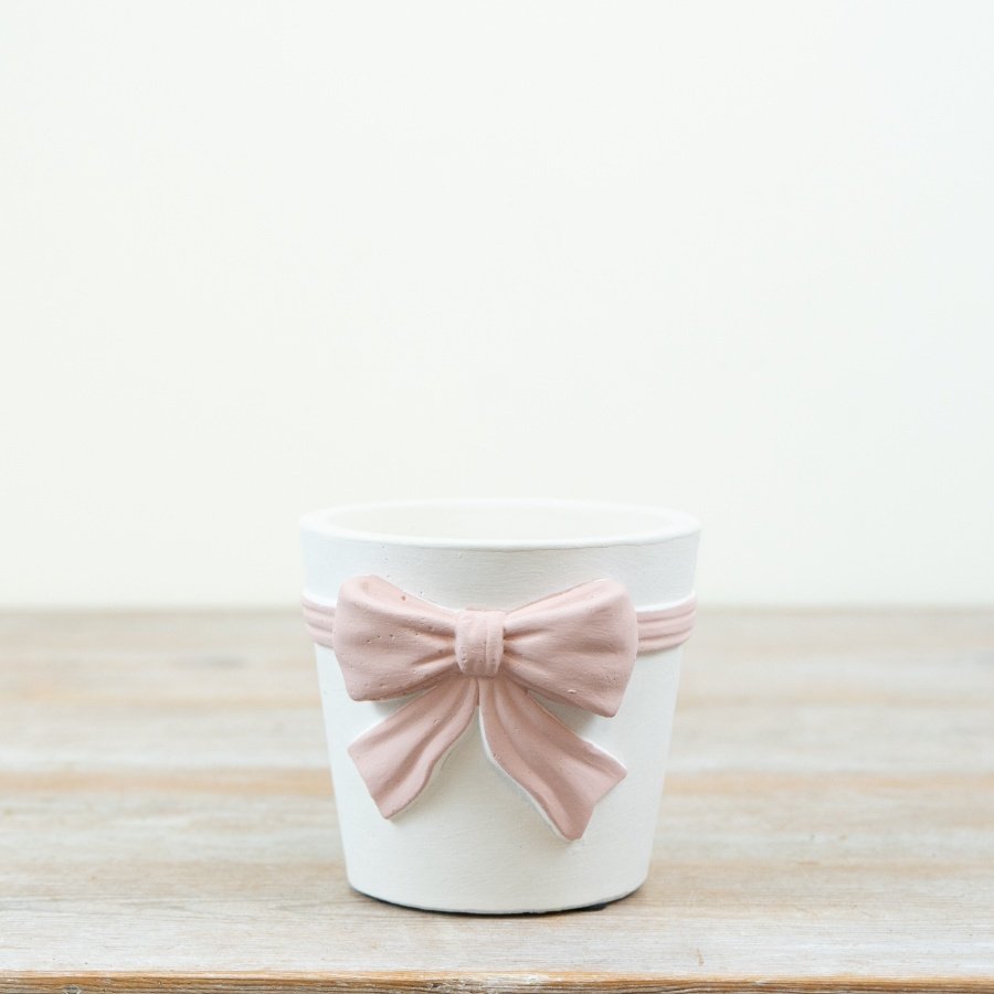 This chic pink and white bow planter makes a stylish statement in any space.