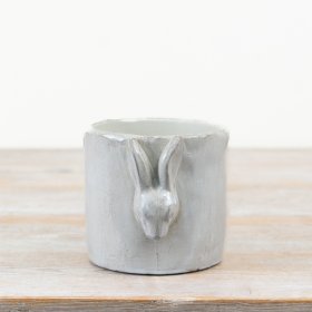 Charming white cement planter with a 3D glazed bunny design,