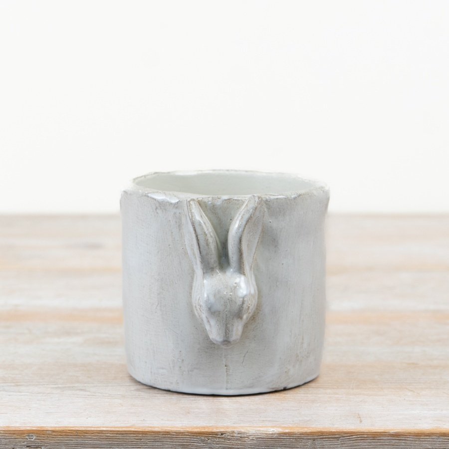 Charming white cement planter with a 3D glazed bunny design,
