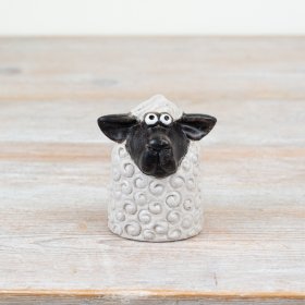 Bring rustic charm to your space with this 8cm black and white sheep figurine, perfect for a cozy vibe.