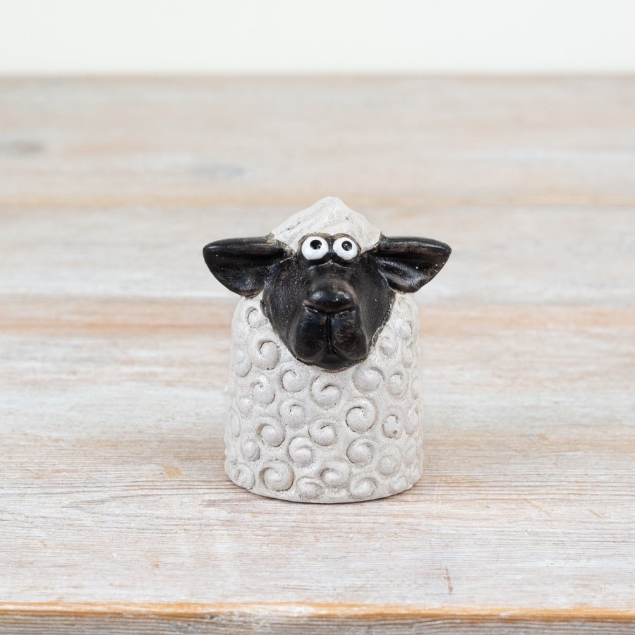 Bring rustic charm to your space with this 8cm black and white sheep figurine, perfect for a cozy vibe.