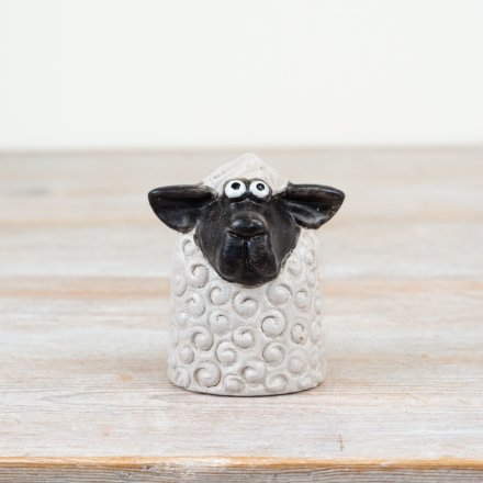 Enhance your spring décor with this stylish black and white Sitting Sheep ornament.
