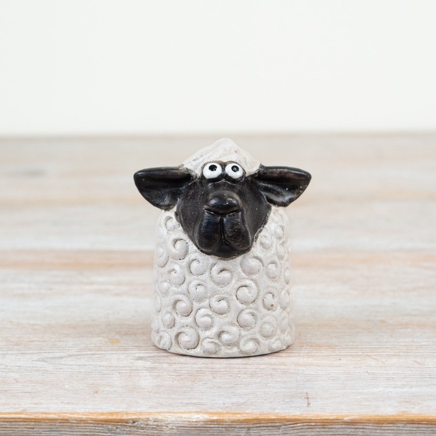 Enhance your spring decor with this stylish black and white Sitting Sheep ornament.