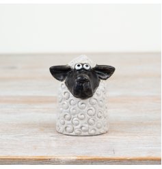 Enhance your spring décor with this stylish black and white Sitting Sheep ornament.