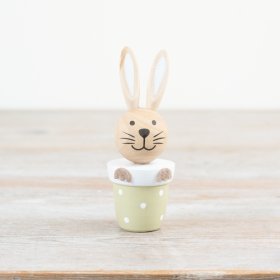 Adorable rabbit figurine nestled in a planter pot.