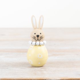 A delightful bunny with a bright yellow flower design.