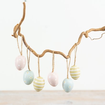 A set of 6 pastel coloured decorative eggs. In pink, blue and green colours with stripes, polkadots and flowers. 
