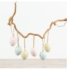 A set of 6 pastel coloured decorative eggs. In pink, blue and green colours with stripes, polkadots and flowers. 