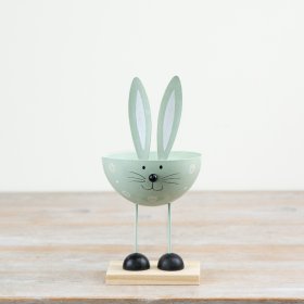 Pastel green bunny decor perched on a wooden base, adding charm to any space.