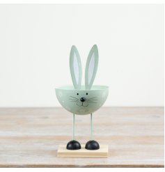 Pastel green bunny decor perched on a wooden base for charming accents.