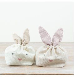 Adorable pink fabric rabbit bag with bunny ears and fun spots—ideal for Easter goodies!