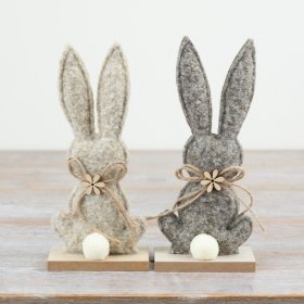 Adorable fabric bunny mounted on a rustic wooden plaque.