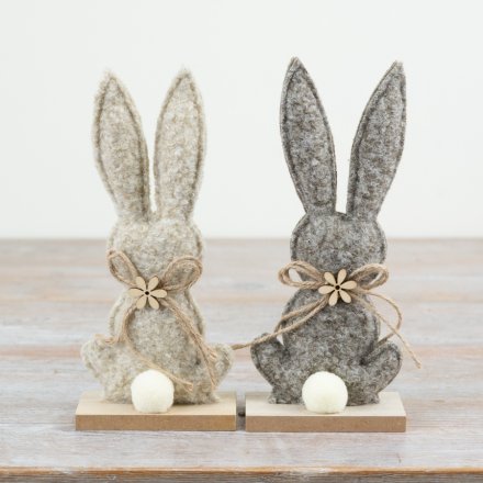 Adorable fabric bunny mounted on a wooden plaque for a cute, rustic touch.