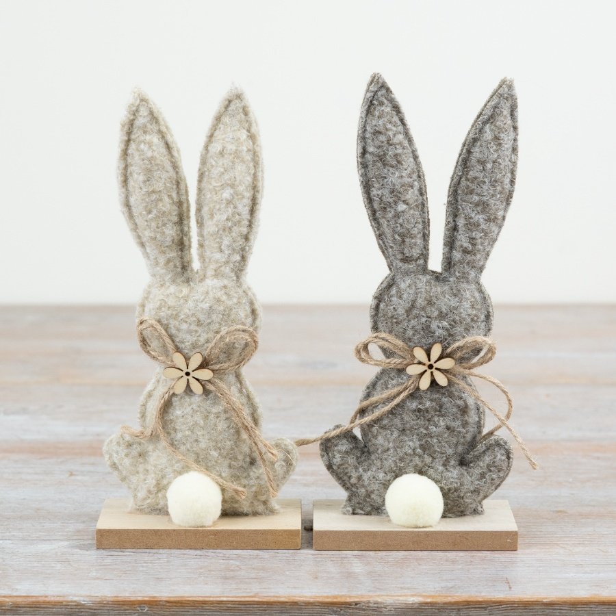 Adorable fabric bunny mounted on a rustic wooden plaque.