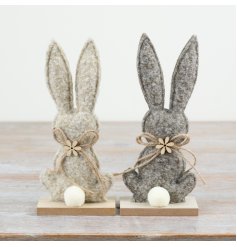Adorable fabric bunny mounted on a wooden plaque for a cute, rustic touch.