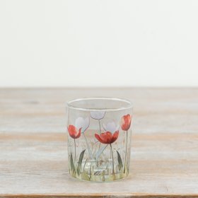 Elegantly designed glass candle holder featuring a delicate flower pattern.