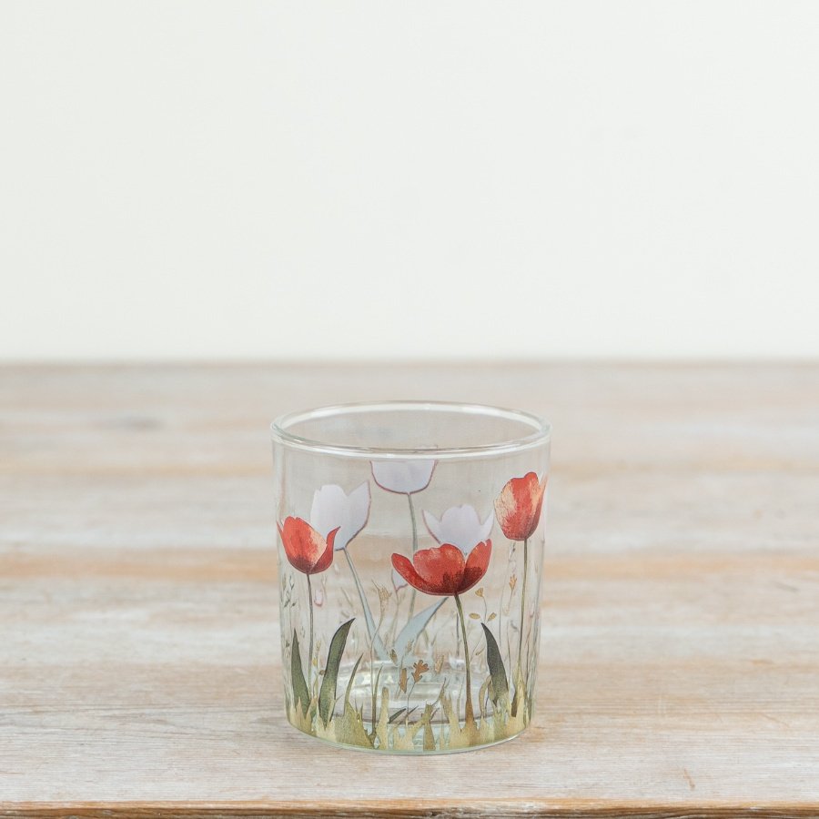 Elegantly designed glass candle holder featuring a delicate flower pattern.