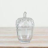 A glass acorn pot featuring intricate cut outs on the lid, an ideal pot for storing nuts or treats! 