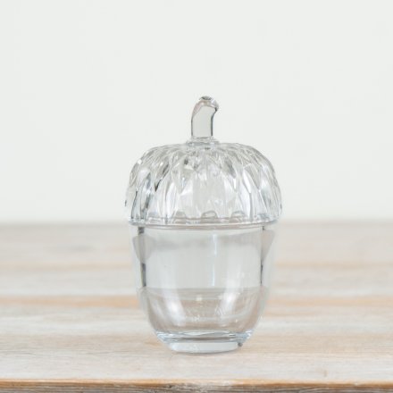 A glass acorn pot featuring intricate cut outs on the lid, an ideal pot for storing nuts or treats! 