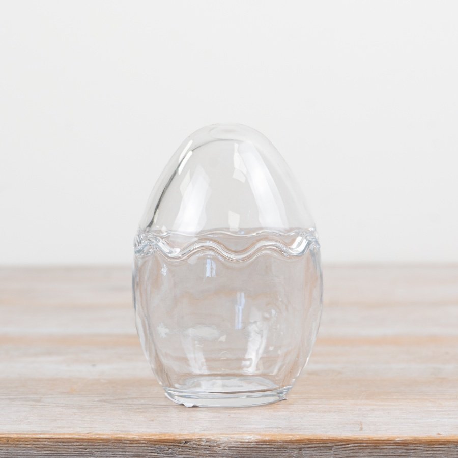 Egg-shaped jar with clear standing design perfect for display or storage.