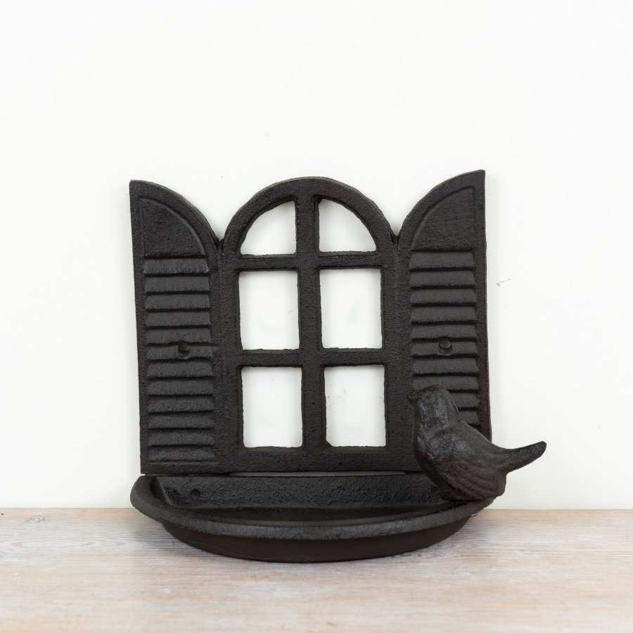 Rustic cast iron bird feeder showcasing a charming open window design.