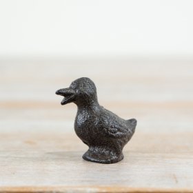 Small cast iron duck figurine with open beak, full of charm.