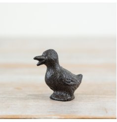 A charming little duck made from cast iron, displaying its beak open.