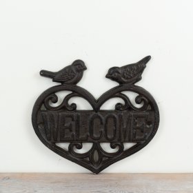 Cast iron rustic welcome sign showcasing a charming heart-shaped design.